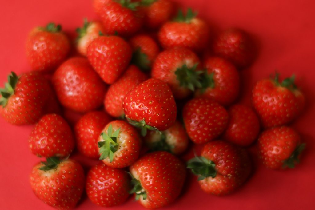 Strawberries on red background