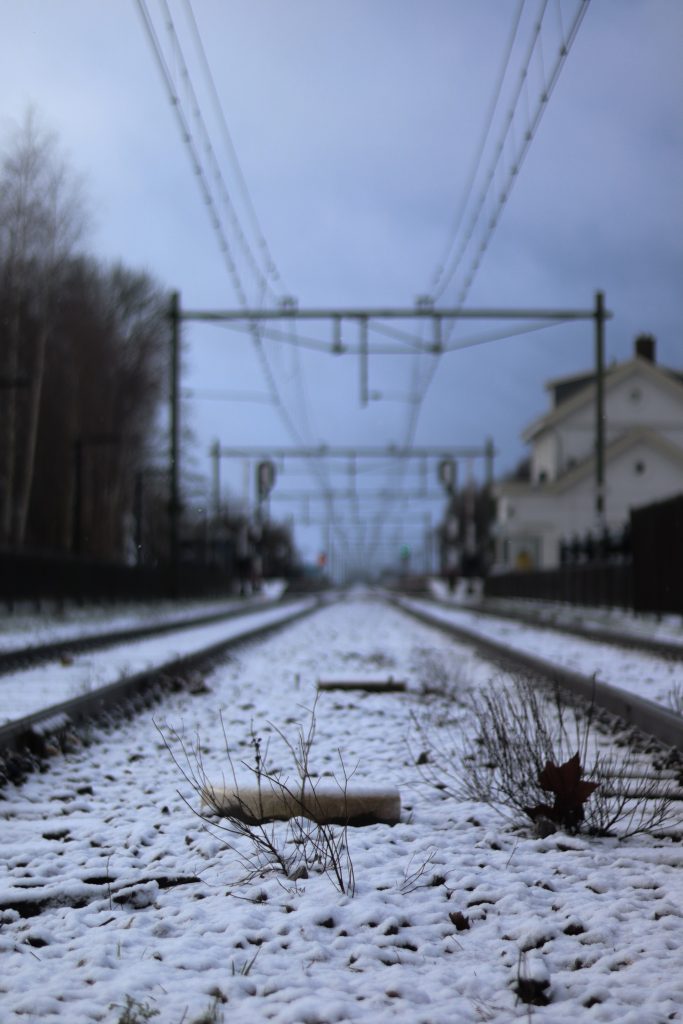 Snowy train railway tracks in Zevenbergen