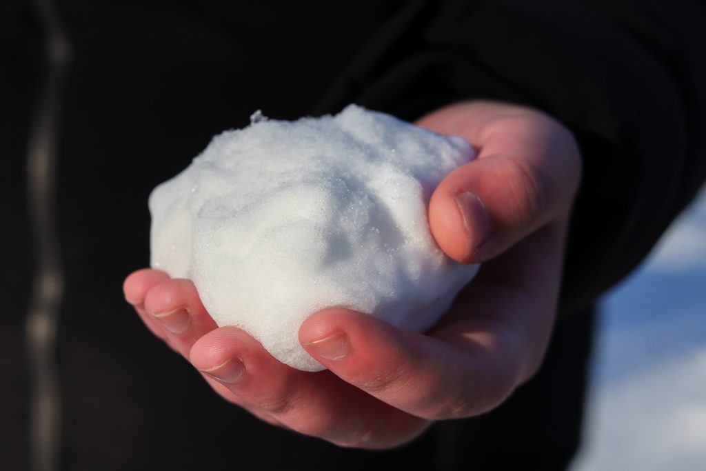 Man holding snowball in his hand