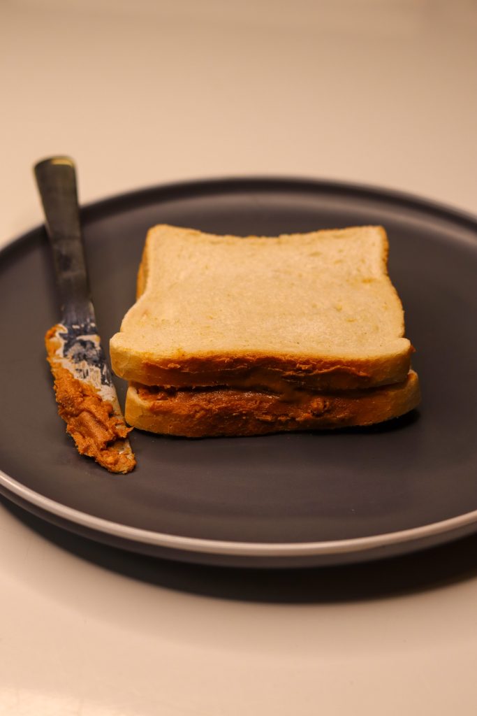 peanut butter sandwich with knife on the side
