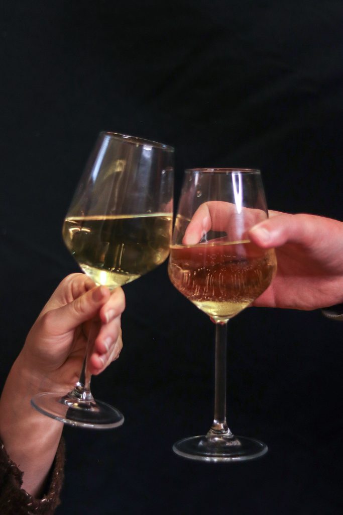 Wine glasses toast together