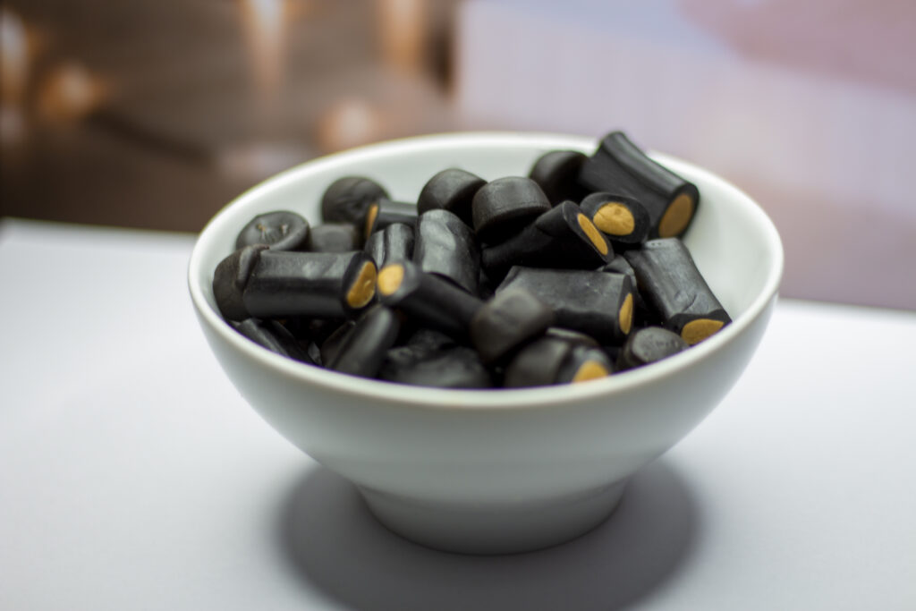 Licorice in a white bowl seen from above