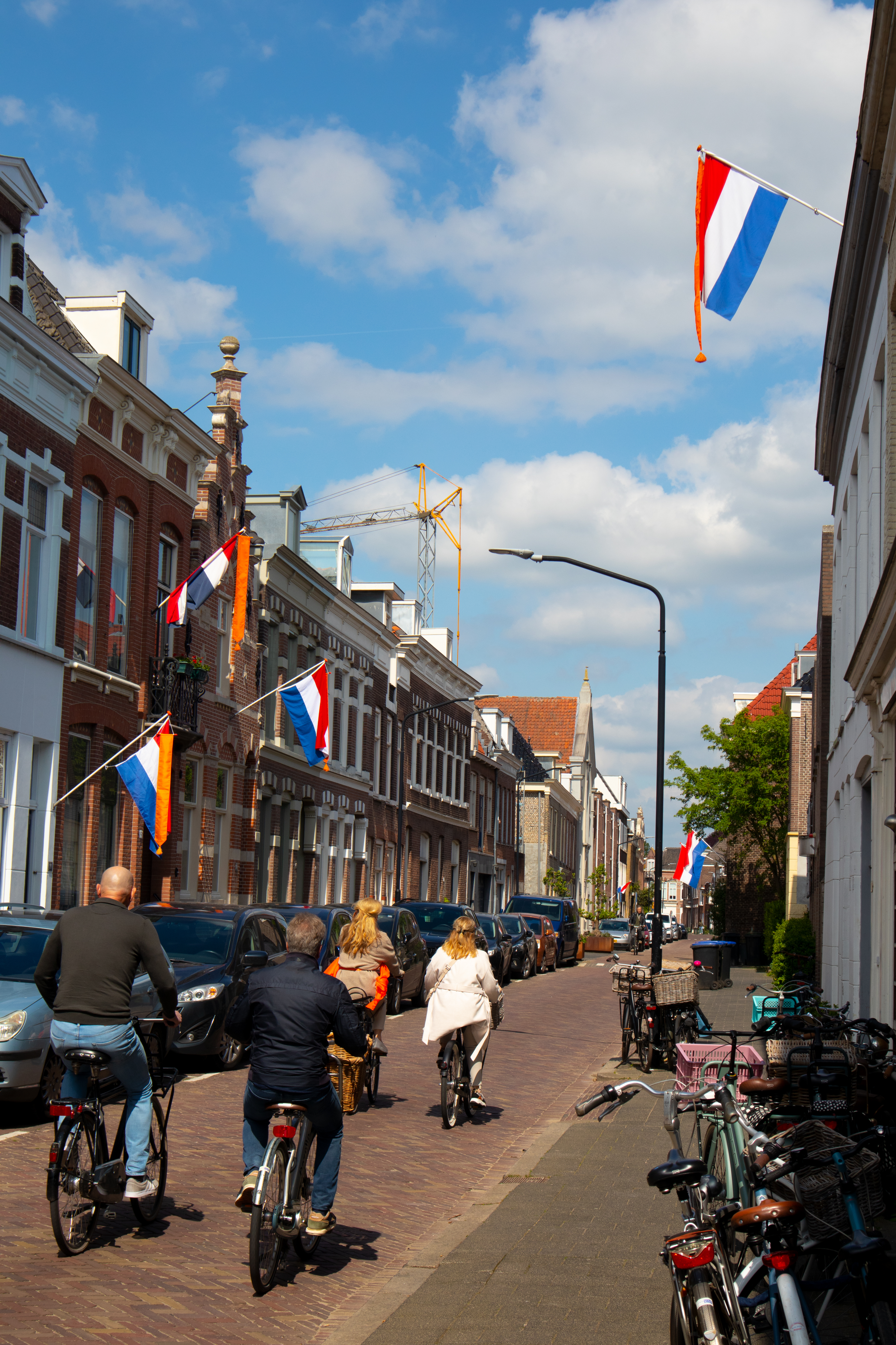 on bike riding to king's day festivities with Dutch flags in the streets