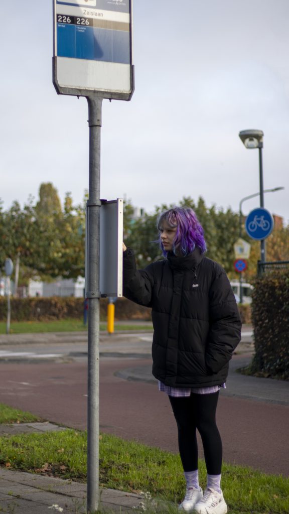 Girl with purple hair using public bus