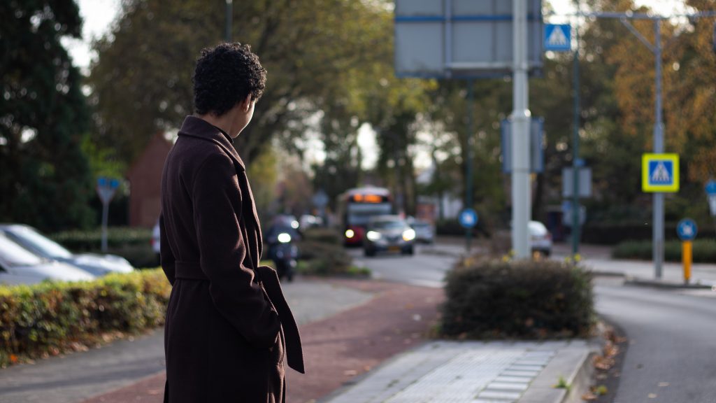 Young girl waiting for bus at bus stop