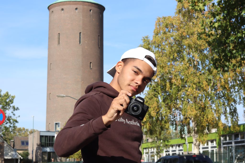 Man Holding Camera Near Tower