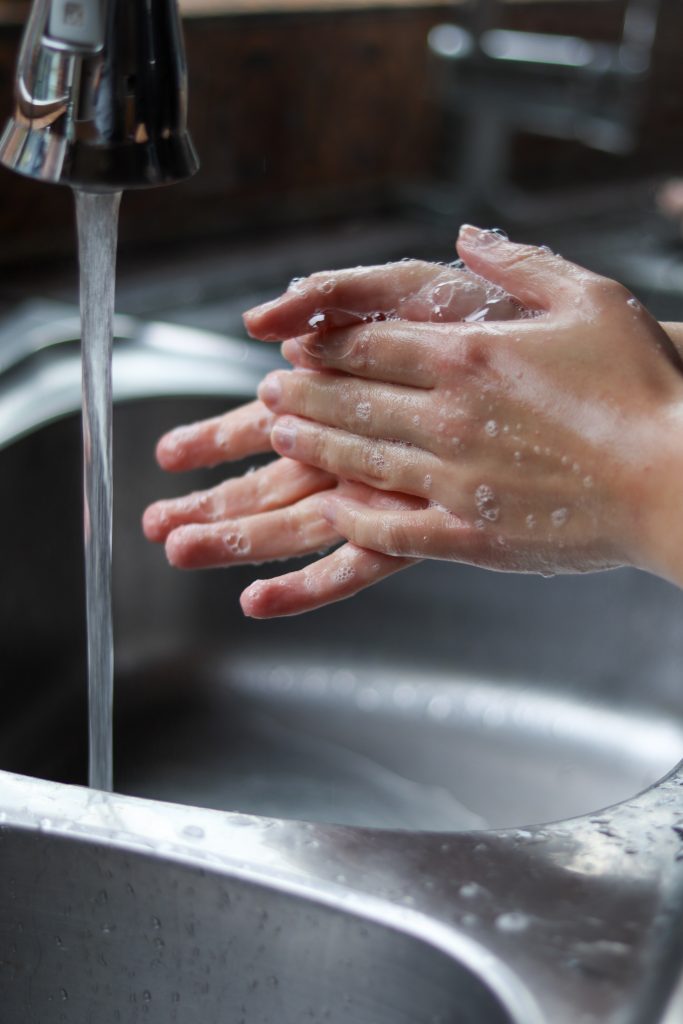 hands close to wash tap