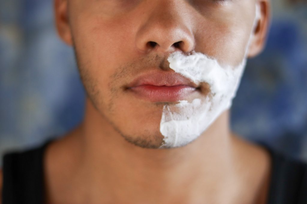 Movember shaving foam on one side of face