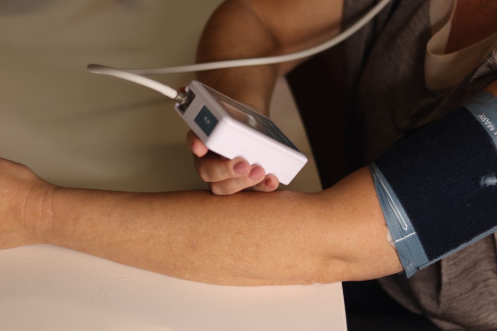 Woman holding blood pressure monitor from different angle