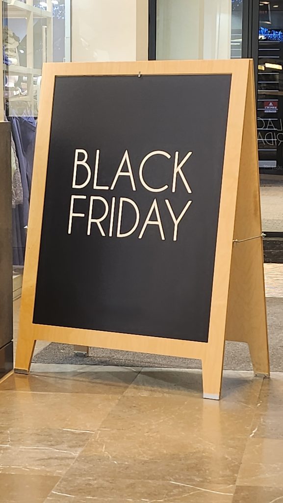 A black board in the street during Black Friday