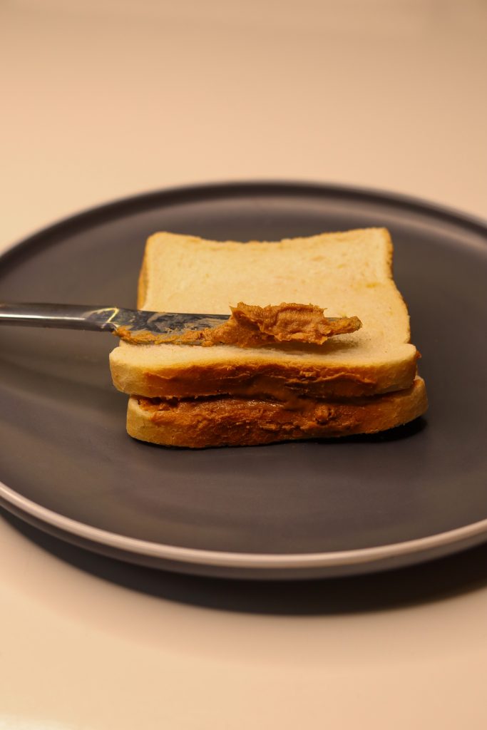 peanut butter sandwich with knife on top
