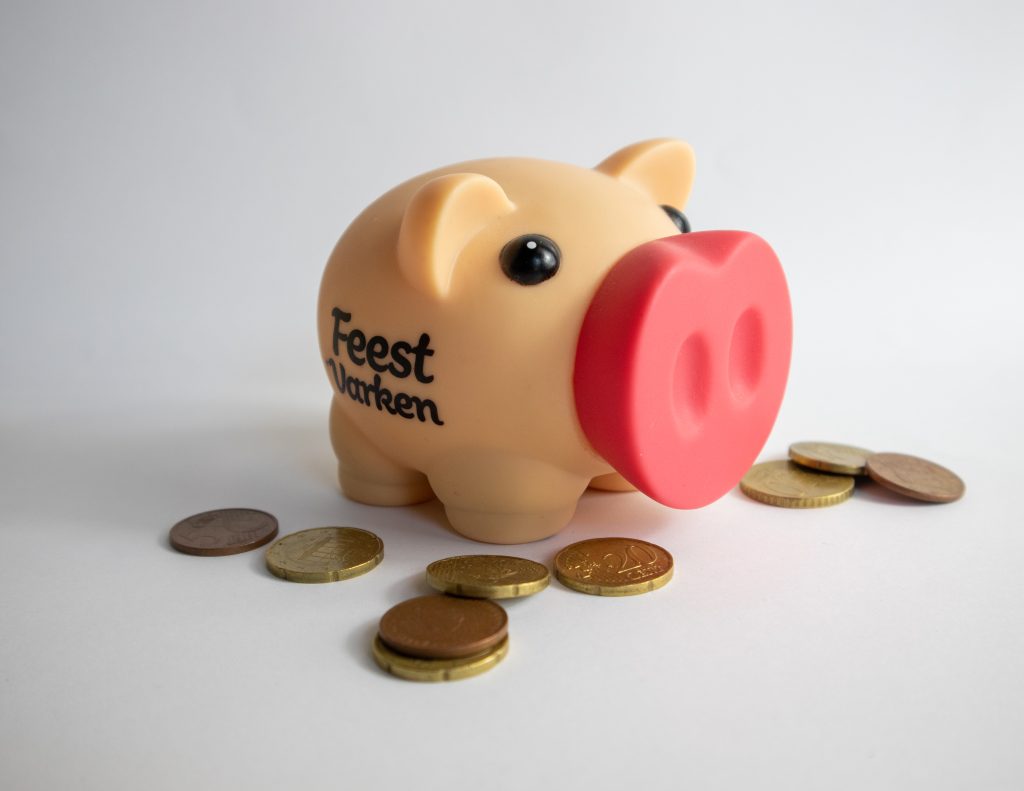 A piggy bank surrounded by coins